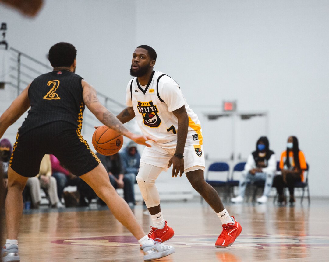 Charles Baskin dribbles on the perimeter during Flint United's home opener on April 16.