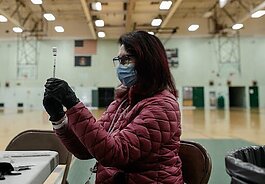A Genesee County Health Department Registered Nurse prepares the Pfizer vaccine at the first mobile vaccine clinic in Flint at Northwestern High School.