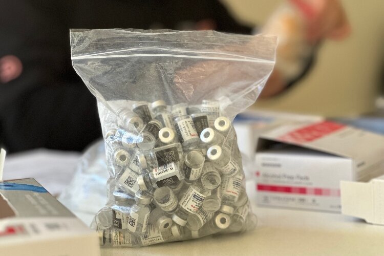 The bag is filled with all the empty COVID vaccines administered during the clinic.