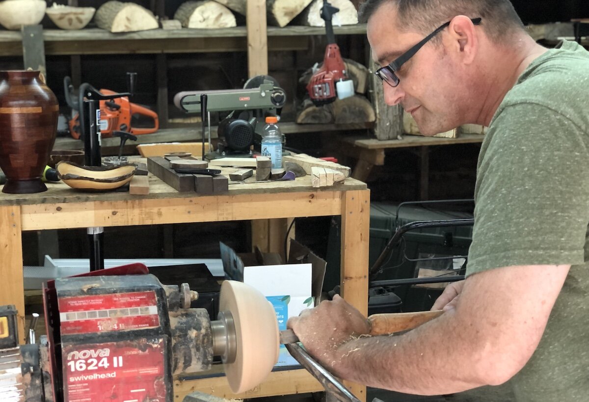 Russ Dotson creating a wood bowl on his lathe in his College Cultural Neighborhood garage.