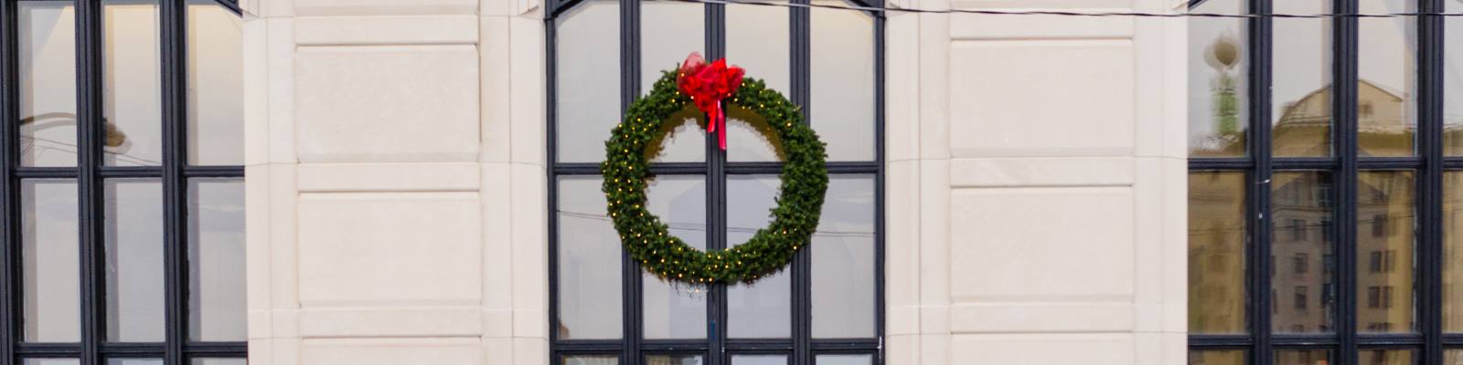 The Weather Ball is reflected in the windows of the Mott Foundation building, all decked out for the holidays.